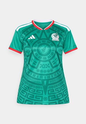 Green soccer jersey featuring intricate patterns, white and red accents, V-neck design, and a logo on the chest. Made from breathable material.