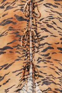 Sheer fabric featuring a tiger stripe pattern in black and brown. Center has ties and a zipper closure, with a smooth texture.