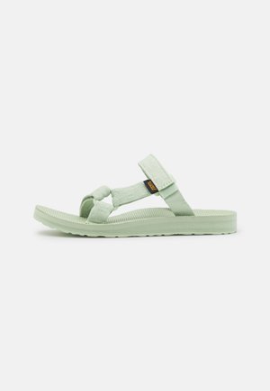 Light green sandals featuring adjustable straps, textured footbed, and a soft rubber sole with a ridged pattern for traction.