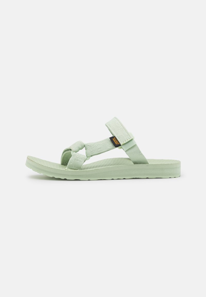 Light green sandals featuring adjustable straps, textured footbed, and a soft rubber sole with a ridged pattern for traction.