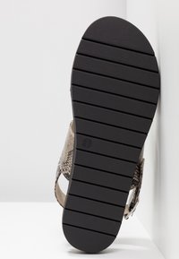 Sandal yang dapat disesuaikan dengan bagian atas kulit ular coklat berpola tekstur, sol karet hitam dengan lekukan horizontal, ukuran ditandai sebagai 37.