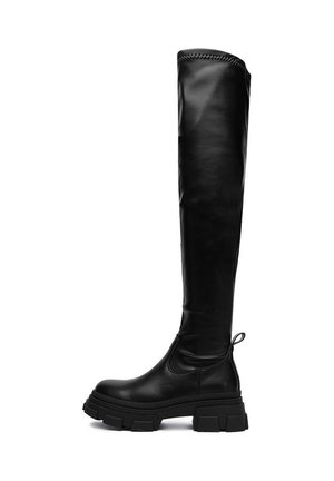 Botas de cuero negras hasta la rodilla con suela gruesa, textura suave y una lengüeta. Presentan un acento cosido en la parte superior.