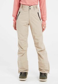 Beige skibroek met hoge taille, twee zwarte ritszakken en een recht gesneden ontwerp. Kenmerken zijn zichtbare stiksels en een minimalistische stijl.