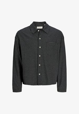 Chemise à manches longues à carreaux noir et blanc avec col et poche poitrine, présentée sur un fond blanc.