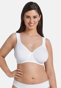 Seno bianco senza cuciture con spalline regolabili, coppe sagomate e una superficie liscia. Progettato per comfort e supporto, adatto per un uso quotidiano.