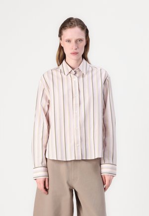 Striped button-up shirt with pastel pink and yellow lines, featuring a collar and oversized fit. Fabric appears smooth and soft.