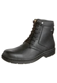 Bottine en cuir noir avec bout arrondi, lacets à l'avant, œillets métalliques et finition texturée. Semelle en caoutchouc durable et détails de coutures.