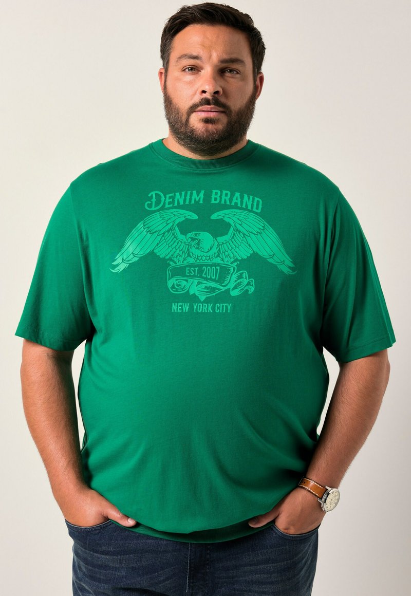 Tyrkysové tričko s krátkým rukávem a grafickým potiskem orla a textem "DENIM BRAND EST. 2007 NEW YORK CITY." Tkanina vypadá hladce, má kulatý výstřih.