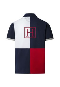 Polo à manches courtes avec des blocs de couleur bleu marine, blanc et rouge, et un logo "H" contour rouge centré dans le dos.