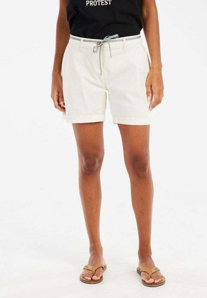 Shorts blancs en coton léger avec une taille élastiquée à cordon, ornés d'un motif à carreaux bleu et blanc. Le modèle porte des tongs.