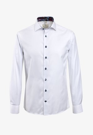 White dress shirt with long sleeves, a spread collar, and navy buttons. Interior collar features a floral pattern. Smooth, glossy fabric texture.