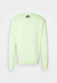 Hellgrüner Sweatshirt mit langen Ärmeln und Rundhalsausschnitt. Hat ein schwarzes "Nike Air"-Logo auf der Rückseite. Glatte Textur, normale Passform.
