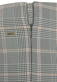 Plaid fabric top features black, white, and orange patterns with a zip closure and a small gold logo tag. Textured weave enhances design.