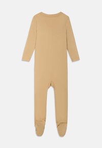 Body a maniche lunghe in cotone beige chiaro, dotato di colletto rotondo e gambe con piedi, con suole testurizzate per una buona aderenza. Materiale morbido e elastico.