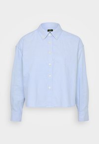 Šviesiai mėlyna, trumpa mygtukų marškiniai, pagaminti iš minkštos medžiagos, su klasikiniais apykaklėmis, priekyje mygtukais ir ilgomis rankovėmis su užsegamais rankogaliais.