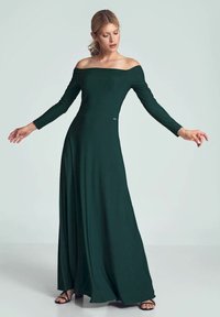 Off-shoulder maxi-jurk in donkergroen met lange mouwen, gemaakt van soepele, rekbare stof, met een getailleerde bodice en een vloeiende rok.
