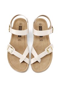 Sandali in pelle beige con cinturini incrociati, fibbia regolabile alla caviglia e soletta in ecopelle scamosciata color nocciola. Taglia 37 indicata sulla suola.