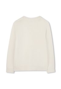 Κρέμα φανέλα με στρογγυλή λαιμόκοψη, μακριά μανίκια και ριμπ στο τελείωμα των μανικιών και στο κάτω μέρος. Η πλάτη είναι λεία, χωρίς σχέδια ή διακοσμήσεις.