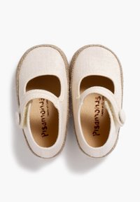 Beige fabric Mary Jane shoes with a linen texture, round toe, adjustable strap, and a natural jute sole. Branding visible inside.