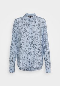 Blusa a maniche lunghe di colore azzurro chiaro con colletto, con un motivo astratto nero su tutto il tessuto. Realizzata in un materiale morbido con una vestibilità comoda.