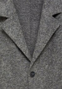 Gray wool coat featuring a notched collar, textured fabric, and a single button closure at the front. Clean lines and modern design.