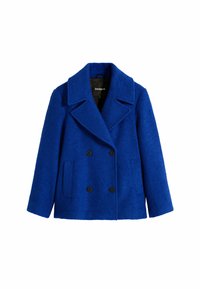 Manteau bleu à double boutonnage en tissu texturé, avec un col cranté, deux poches avant et des boutons noirs.