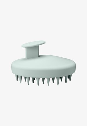 Silicone hair scalp massager, oval shape, pale green color, features soft, rounded spikes for gentle stimulation and a handle for grip.