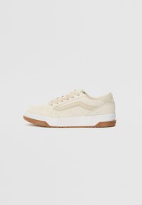 Beige suede sneakers with white soles and gum rubber outsole. Features lace-up design and perforated accents on the side.