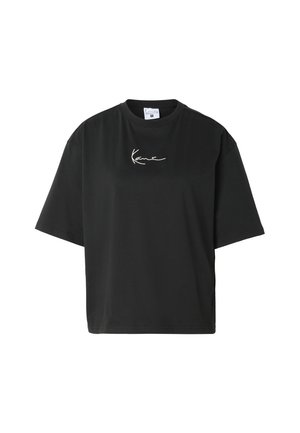 T-shirt noir oversize à manches courtes avec col rond et petit logo blanc en cursive centré sur la poitrine.