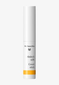 White cylindrical cover stick with a yellow accent at the base. Label features black text and a logo. Smooth texture, compact design.
