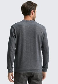 Grauer Pullover mit einem strukturierten Muster, Rundhalsausschnitt und langen Ärmeln. Der Stoff wirkt weich und ist an den Bündchen und dem Taillenbund tailliert.