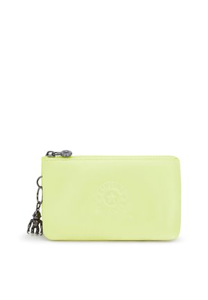 Light green rectangular zippered pouch with circular embossed logo and small silver monkey keychain attached to zipper pull.