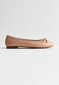 Ballet flats in light beige patent leather, featuring a round toe, a small bow detail at the front, and a thin, flexible sole.