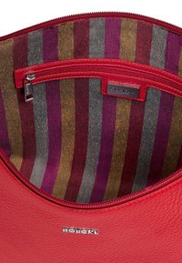 Red leather bag interior with a zippered pocket, featuring multicolored striped fabric in shades of purple, gray, and gold.