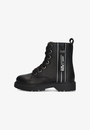 Schwarze Leder-Schnürkampfstiefel mit seitlichem Reißverschluss und weißen Schriftzügen auf dem Streifen, die "LASS DEN REBELLEN RAUS" lesen.