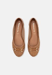 Tan läderskor med slip-on-design, vävt mönster vid tån, detaljer i guldton och en slät innerfoder. Storlek 37.