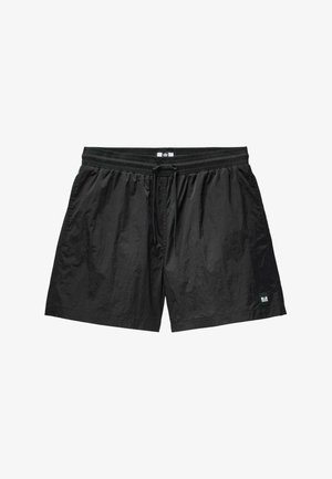 Black swim shorts made of lightweight, textured fabric. Features an elastic waistband with a drawstring and a small brand label detail.