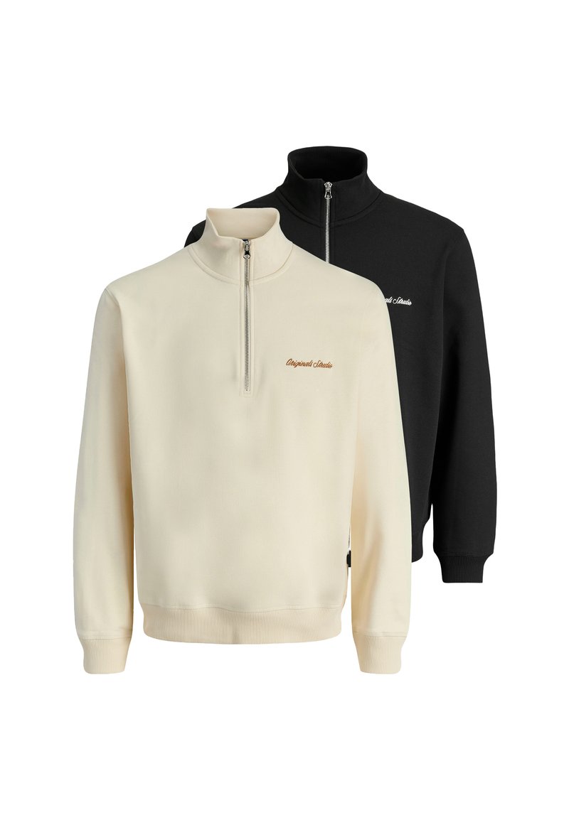 Two quarter-zip sweatshirts: one cream with embroidered text, one black. Both feature long sleeves and ribbed cuffs, made from soft fabric.
