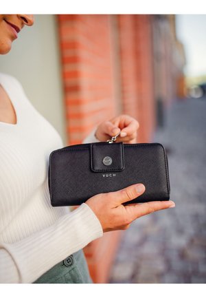 Black textured wallet with a flap closure, silver snap, and "VUCH" branding. It features a rectangular shape and a slim design.