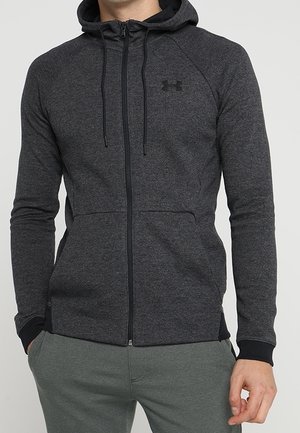 Mørkegrå hættetrøje med lynlås lavet af blødt stof, med snøre i hætten, raglanærmer og et lille logo på brystet.