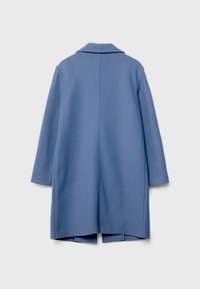 Světlomodrý vlněný kabát s dlouhými rukávy a klopovým límcem, rovný střih a rozparek v dolním lemu. Viditelné detailní švy.