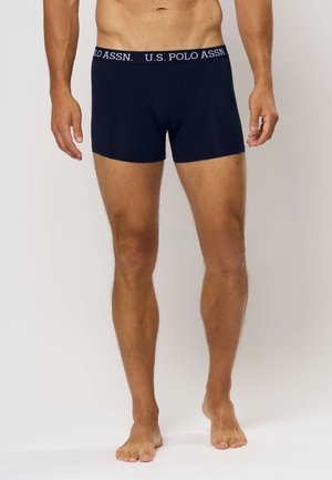 Tumši zila kokvilnas bokseršortos ar mīkstu elastīgu jostasviju, kurā ir balti burti "U.S. POLO ASSN." Slim fit un gluda tekstūra.