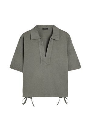 Short-sleeve shirt in olive green, featuring a V-neck, embroidered detailing, and adjustable tie sides. Made from soft fabric.