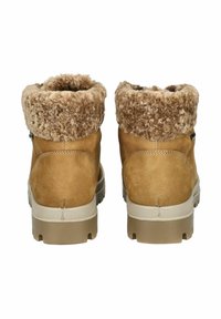 Tan suede ankle boots featuring a fluffy beige faux fur collar, sturdy rubber sole, and stitched detailing on the back.