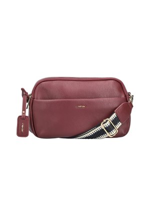 Dark red leather crossbody bag with front pocket, silver zipper, gold logo, and black-and-white adjustable shoulder strap.
