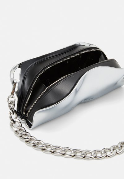 Silver metallic bag with a curved shape and black leather interior. Features two zippered compartments and a chunky silver chain strap.