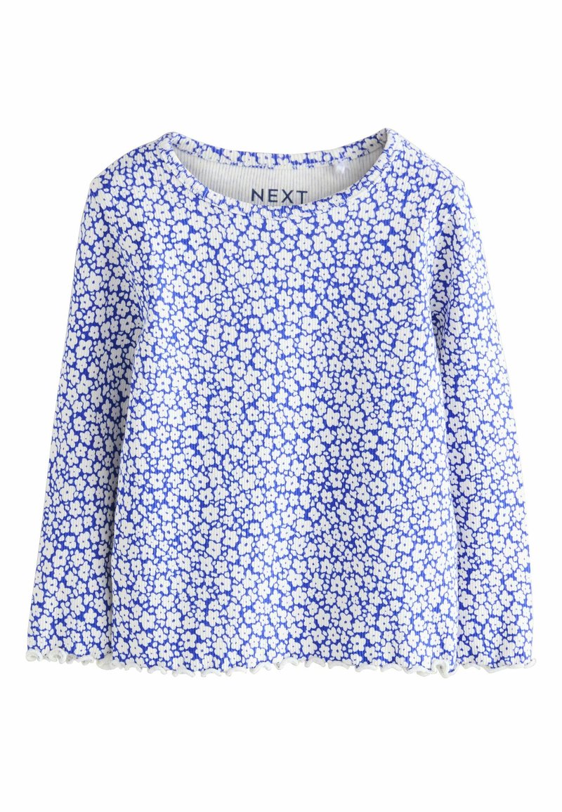 Kerek nyakkivágású hosszú ujjú felső. Kék alapon apró fehér virágmintákkal. Csipkés szegély az alján.