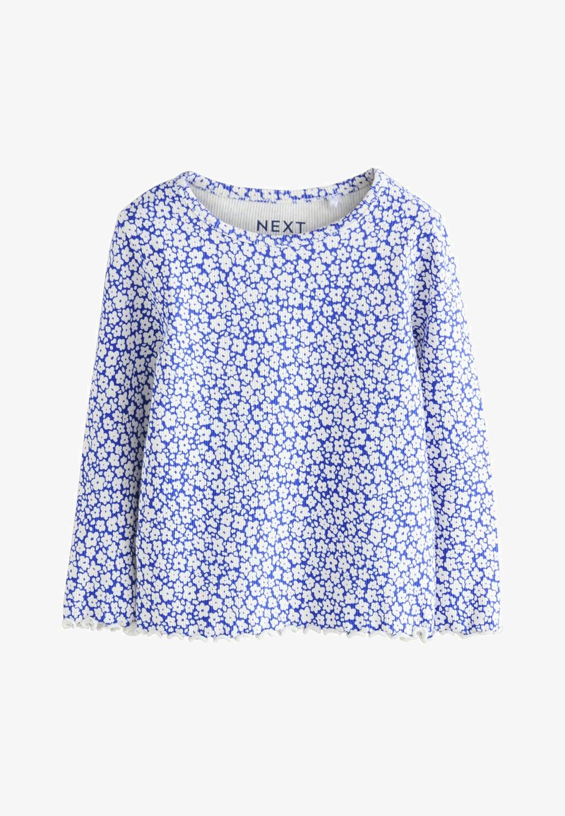 Long-sleeve top with a round neckline. Features a blue background with small white floral patterns. Scalloped hem at the bottom.