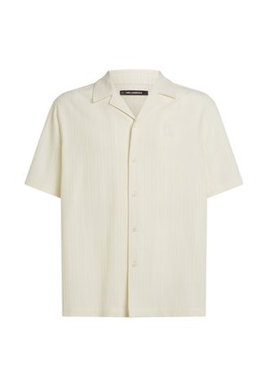 Korte mouwen overhemd met knopen in licht beige met een subtiel gestreept textuurpatroon. Voorzien van een klassieke kraag en standaard pasvorm.