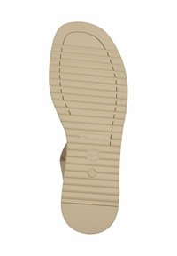 Suola di scarpa in gomma beige con scanalature orizzontali e punta arrotondata, con logo dell'azienda e indicazione della taglia. Area superiore testurizzata per grip.